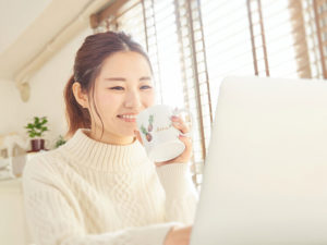メールを読む笑顔の女性